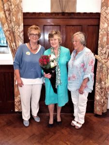 Liz Hobcraft with flowers and the two Presidents