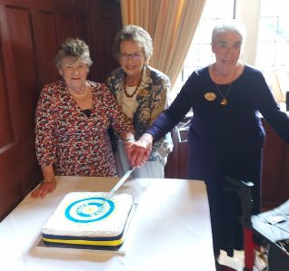 3 founder members cutting the cake